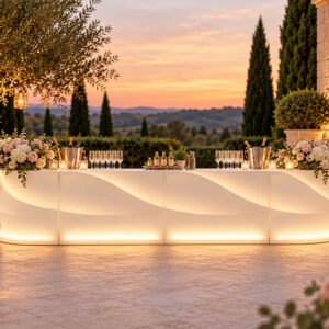Bar lumineux Baraonda composé de deux modules droits et deux modules d'angle, installé sur une terrasse de domaine dans une ambiance de mariage élégante.